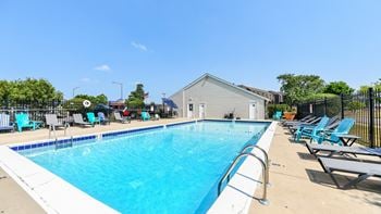 Outdoor pool with lounge seating and poolhouse